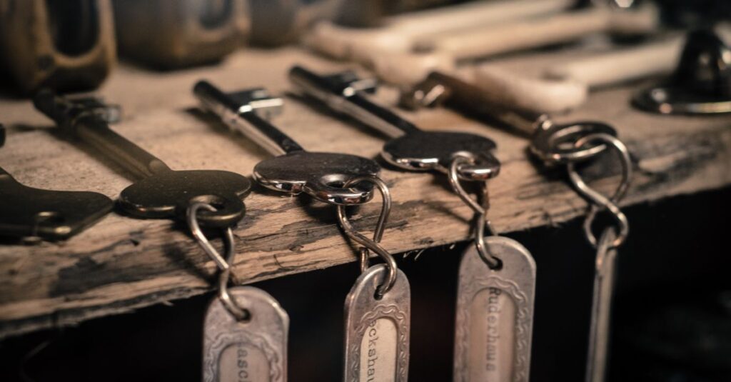 Crypto Private Key Security: Why Lost Keys Cause 40% of Hack Losses A detailed shot of antique metal keys with keychains hanging on a rustic wooden surface.