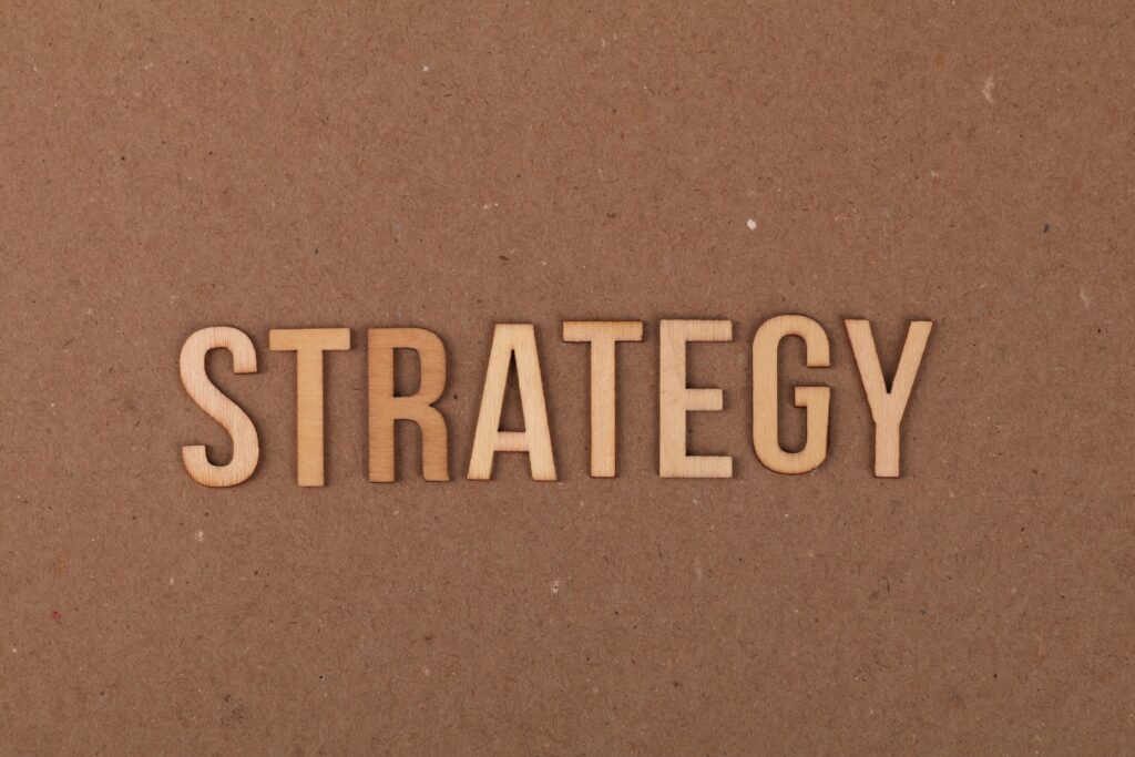 Saylor Blinks Wooden letters spelling 'Strategy' on a cardboard background, perfect for business concepts.