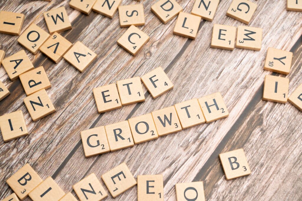 The Altcoin ETF Flood: XRP, Solana, Dogecoin Get Their Moment Wooden tiles spelling ETF growth on a wooden surface, symbolizing investment strategy.