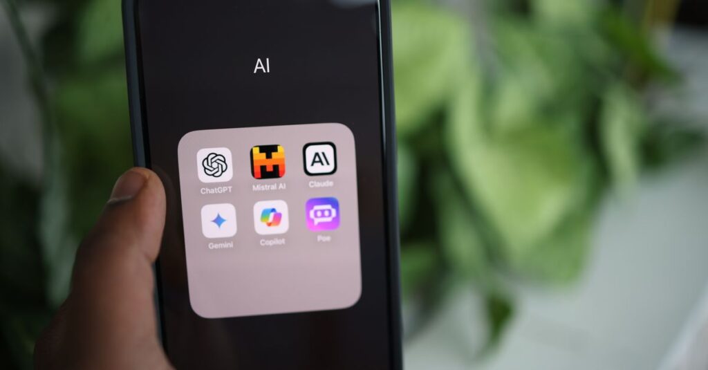 Close-up of a hand holding a smartphone with AI applications on screen.