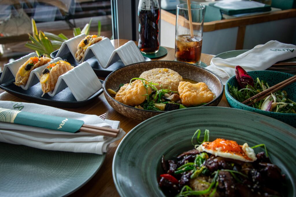 Asia’s 50 Best Restaurants A vibrant display of gourmet Asian cuisine with tacos, rice, salad, and drink.