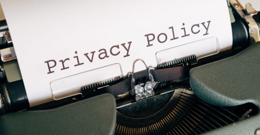 A vintage typewriter writing 'Privacy Policy' on paper, capturing an old-school conceptual theme.