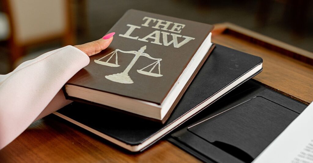 CLARITY Act Crypto Regulation: Why Congress Still Can't Agree Closeup image of a law book titled 'The Law' on a wooden desk with scales of justice.