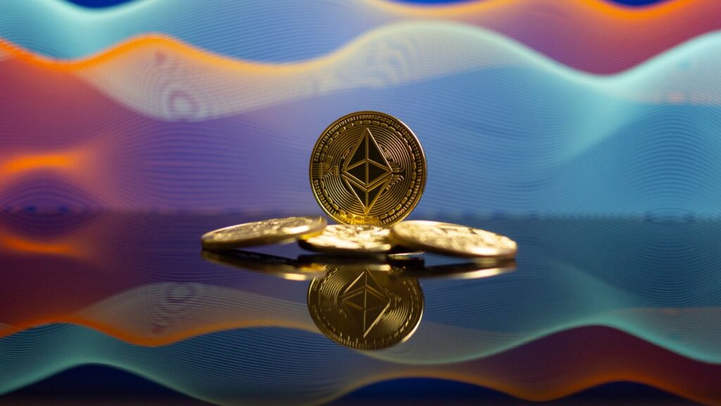 Why Ethereum Going Quiet Is the Loudest Signal Ethereum coins with a reflective surface and vibrant gradient background, representing cryptocurrency and blockchain technology.