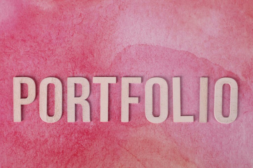 When Everything Falls Together Pink watercolor texture with wooden 'PORTFOLIO' letters.