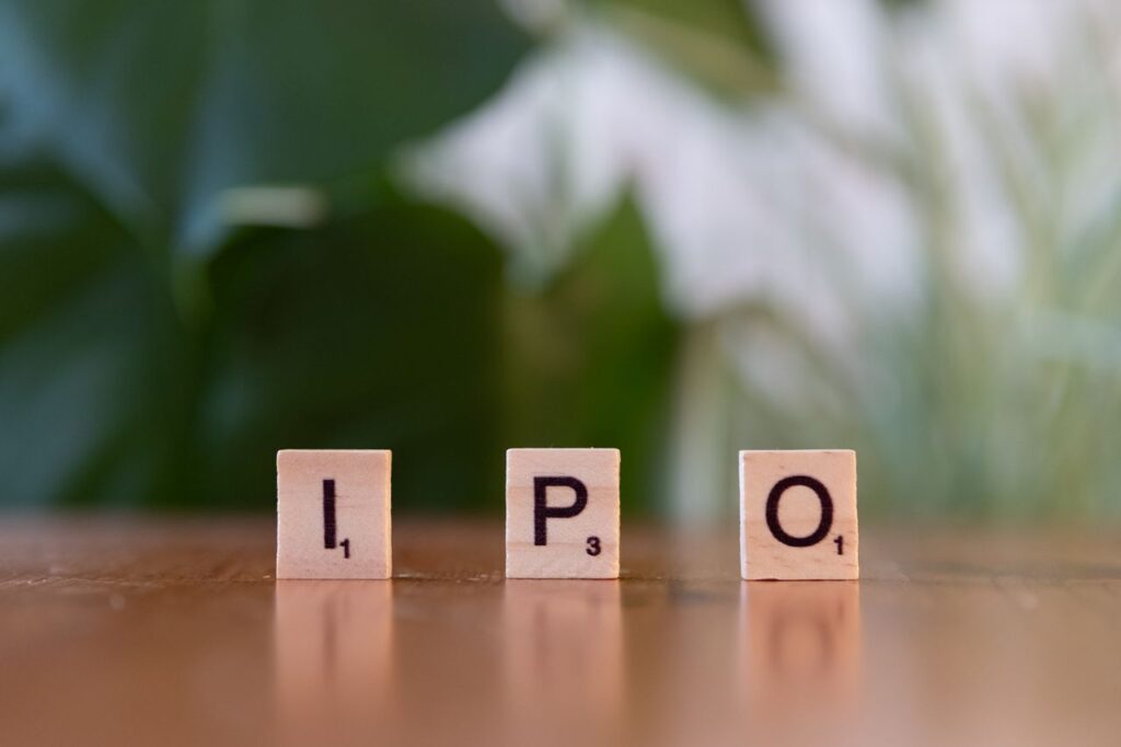 The Trillion-Dollar Gold Rush: What the Coming Wave of Mega-IPOs Means for Your Money Wooden letter blocks spelling IPO on a table, symbolizing investment opportunities.