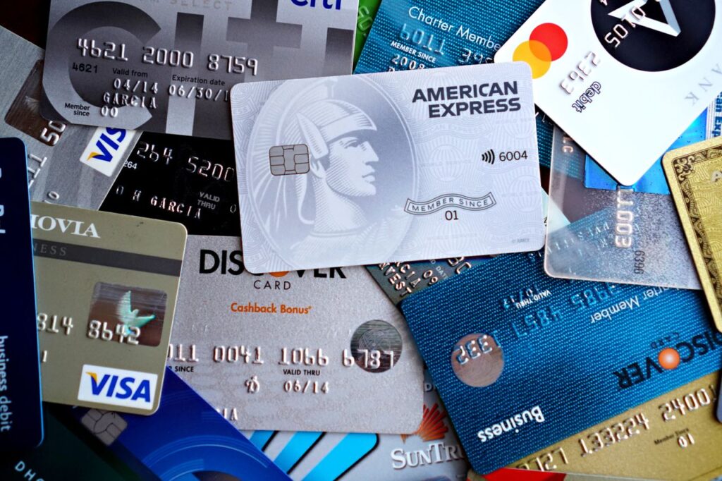 Who Keeps the Interest on Your Digital Dollar? Close-up image of various credit and debit cards including Visa, MasterCard, American Express, and Discover.
