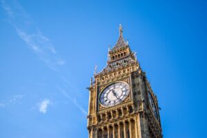 News Stunning low angle view of Big Ben clock tower with a clear blue sky background, London landmark.