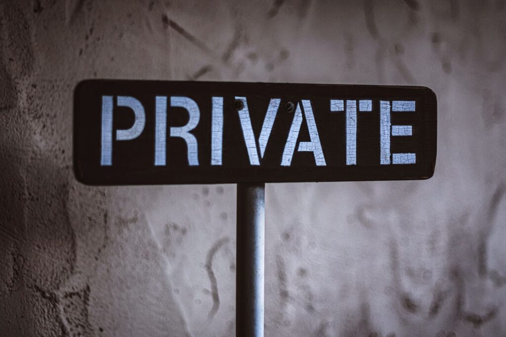 The Lending Market You Never Chose A weathered 'Private' sign on a rustic wall background in Solvang, California.