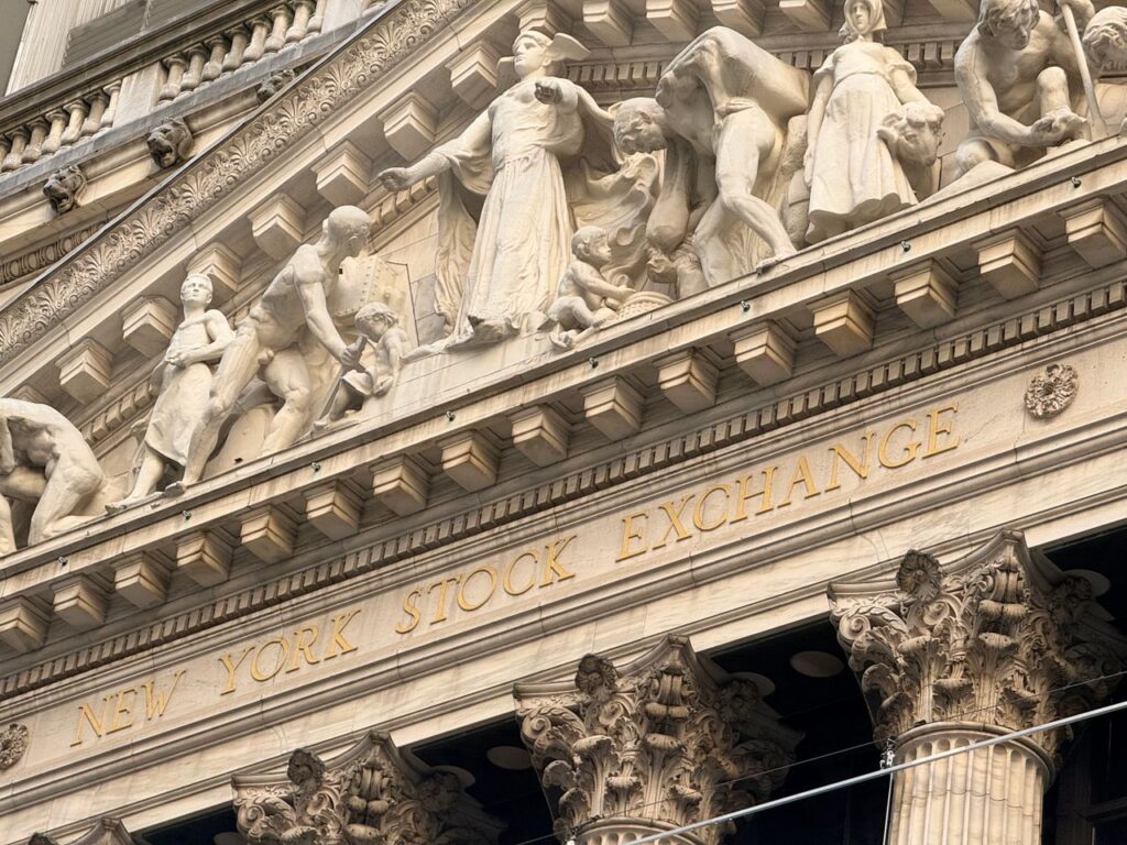 Should You Buy the Hot IPO? Ornate façade of the New York Stock Exchange featuring intricate stone sculptures during daylight.