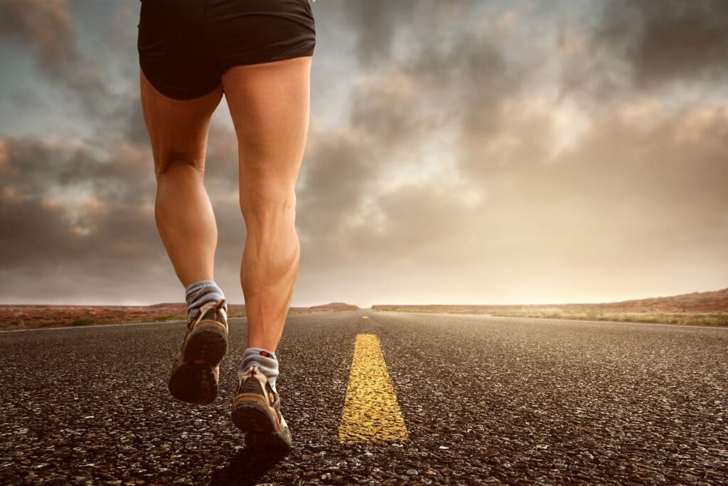 The Asset That Carries Everything Else Runner's legs on a road during a sunset, symbolizing endurance and outdoor fitness training.