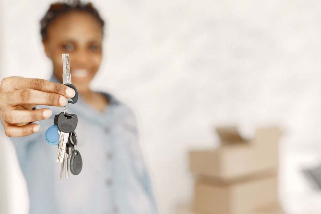 Renting Changed. The Admin Is the Expensive Part Close-up of a woman holding keys with a blurred background, symbolizing a new home or real estate concept.