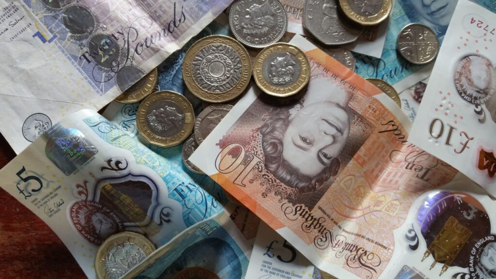 Passive Income Ideas UK: Honest Options Close-up collection of British Pound notes and coins, showcasing UK currency.