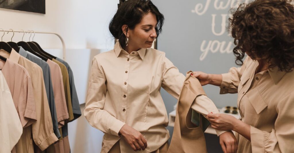 Buy Less, Choose Well Two women shopping in a boutique, examining a shirt together amidst a stylish clothing selection.