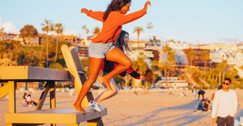 The Underrated Art of the Ordinary Tuesday Group of friends enjoying a lively beach hangout at sunset, capturing moments of joy and freedom.