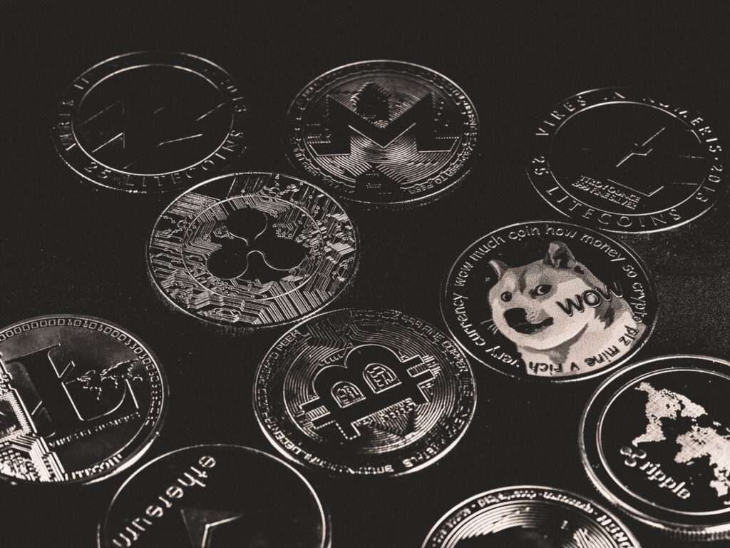 Tokenisation: The Quiet Blockchain Revolution Nobody Warned You About A collection of various cryptocurrency coins including Bitcoin, Ethereum, and Dogecoin.