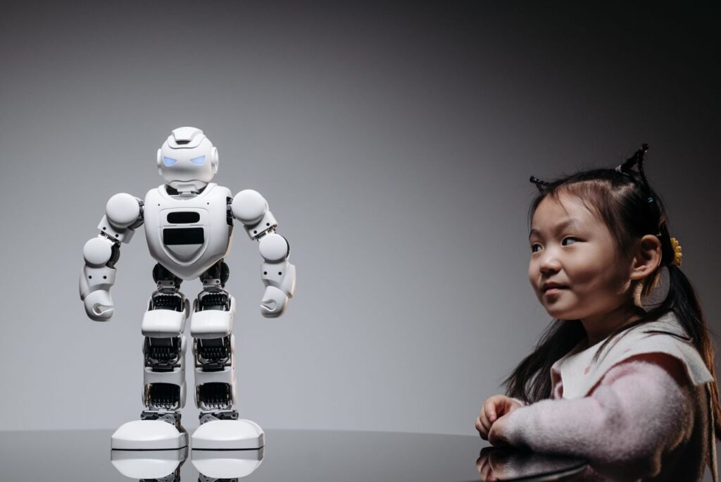 AI and the Future of Learning: Everything Changes But Not in the Way You Think Young Asian girl interacts with a high-tech toy robot, showcasing innovation and curiosity.