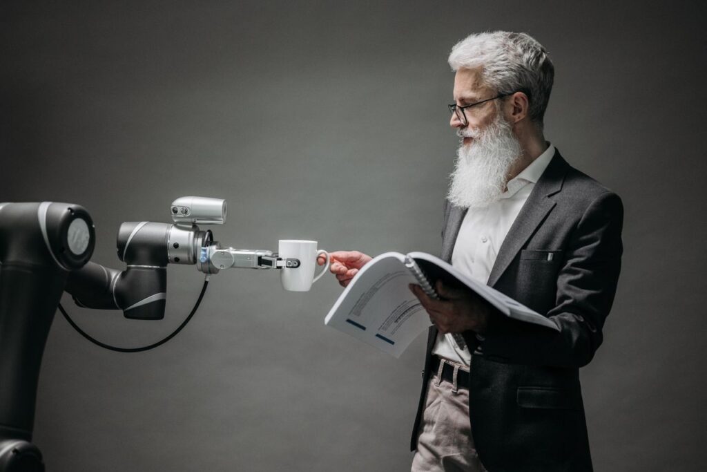 Why Your Next iPhone, MacBook and Xbox Just Got Dearer and What It Reveals About the Hidden Cost of the AI Boom A scientist interacts with a robot helper, demonstrating modern technological innovation.