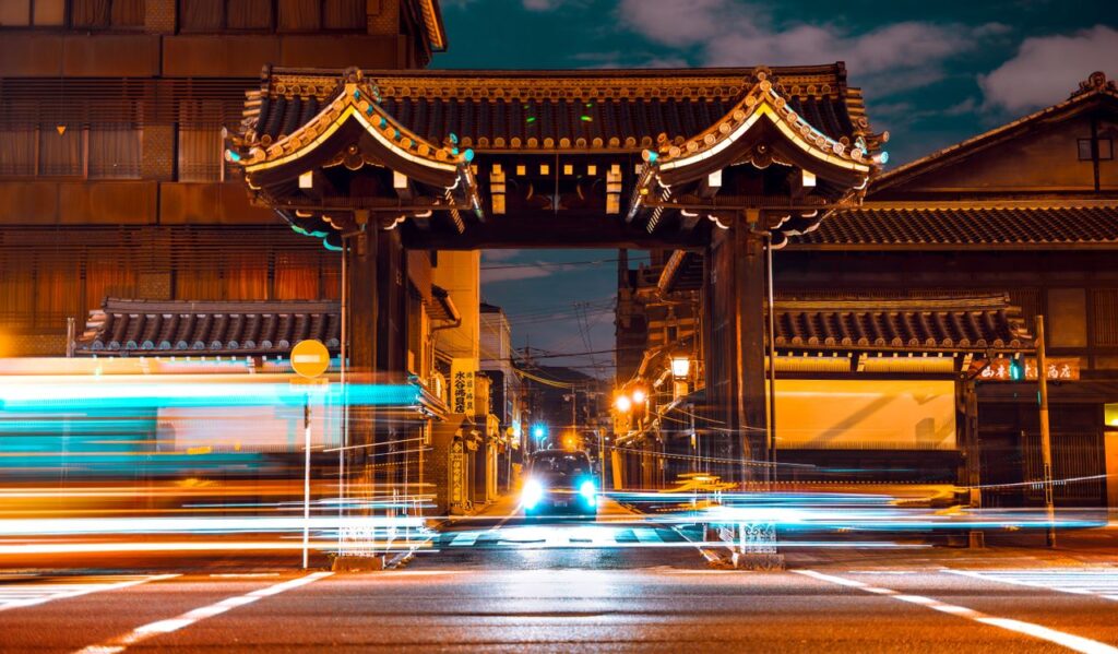 Japan's Weak Yen and Its Quiet Digital Rebuild A vibrant night scene capturing the lively streets and traditional architecture in Kyoto, Japan.