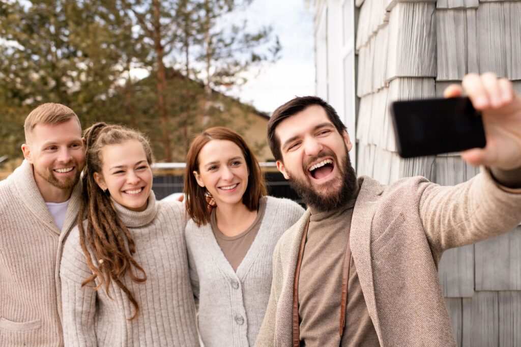 The Friendship That Does Not Appear on a Statement Happy group of friends taking a selfie together, enjoying outdoor time and friendship.