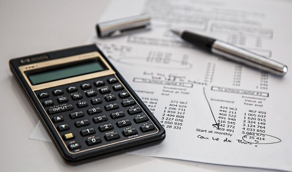 I Audited My Own Spending. Here's What I Found Close-up of financial documents with calculator and pen, ideal for business management themes.