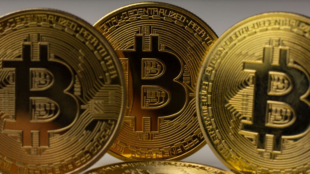 Bitcoin's Average ETF Buyer Is Back in Profit Detailed view of golden bitcoin coins, symbolizing digital currency and blockchain technology.