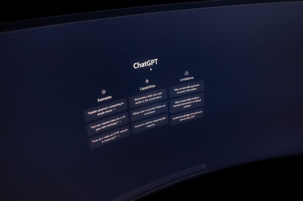This Week's Earnings Are A Verdict On AI Itself Close-up of a computer screen displaying ChatGPT interface in a dark setting.
