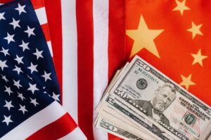 News From above of United States banknotes placed on national flags of America and China illustrating international trade concept