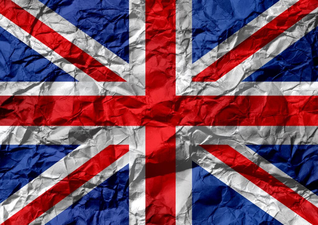 Britain's Economy Slowed. Its Prices Did Not. Grungy textured background designed as full frame flag of United Kingdom on crumpled paper